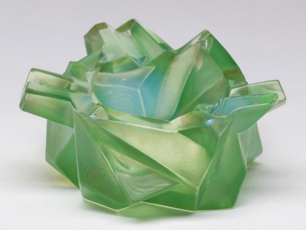 Light green ashtray composed of asymmetrical angles and crisp edges.