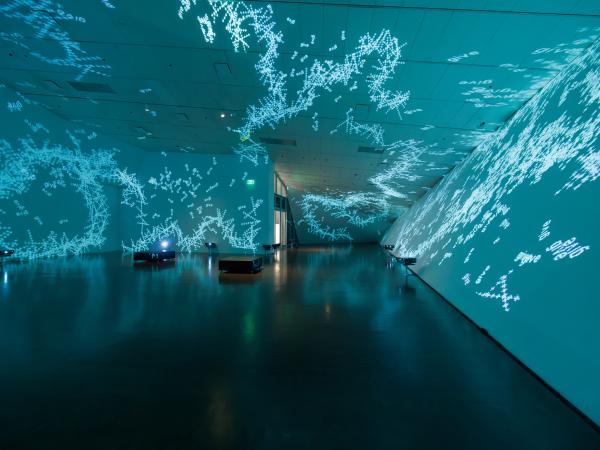 Light blue laser lights in an empty gallery room