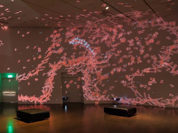 Red-pink lights projected onto a wall
