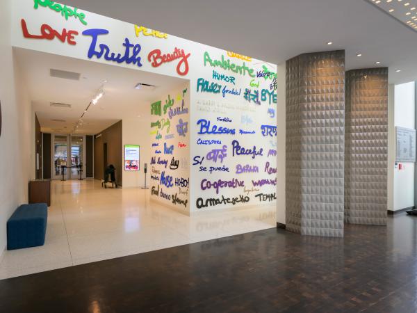 Words in different fonts, sizes, and languages on a wall