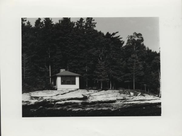Photograph of a home next to a lake