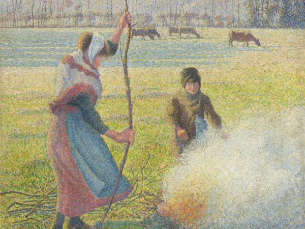 Young girl making a fire in the hoar-frosted countryside