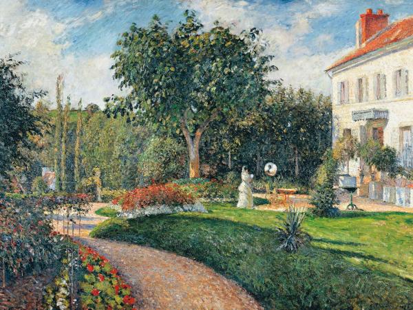 Lush garden of trees and green behind a large white estate