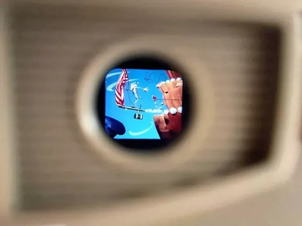 a look through a view master at a color cartoon of Wile E. Coyote falling from cliff